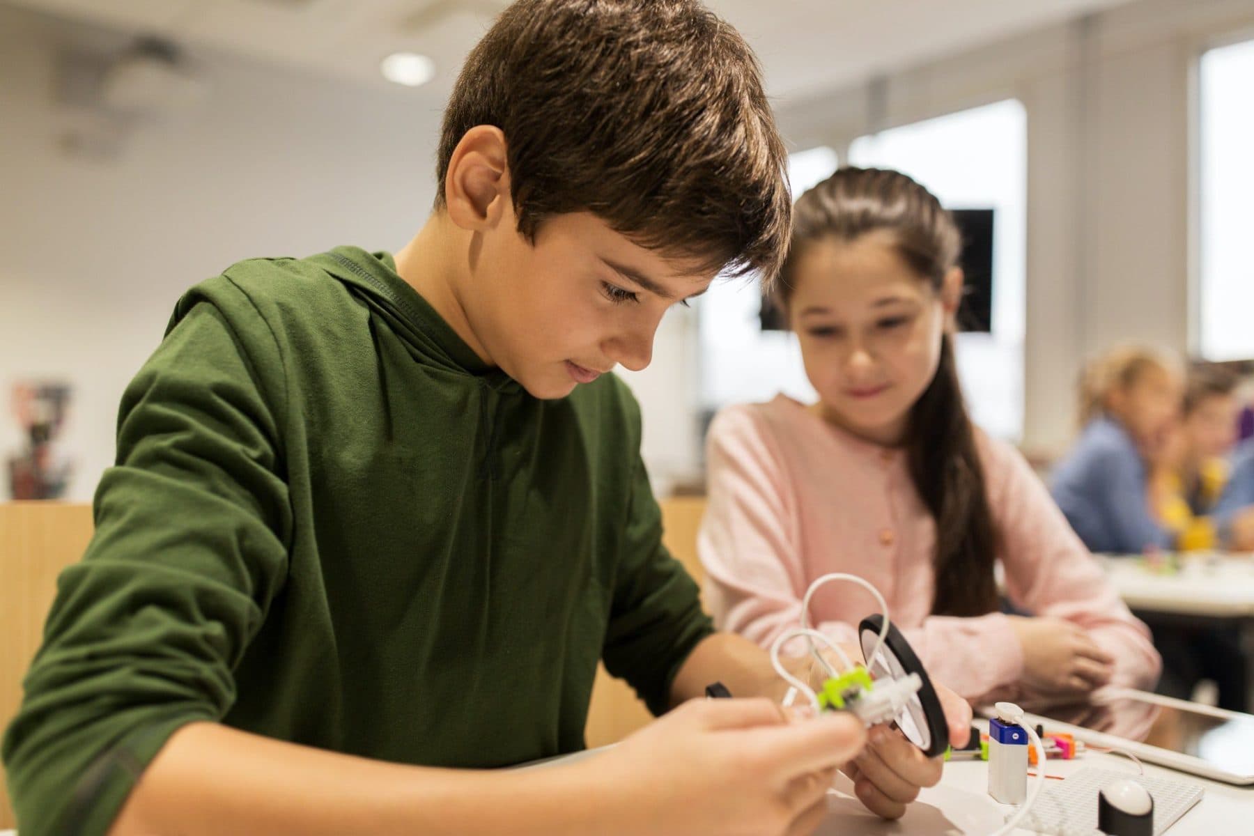 Happy children building robots at robotics school