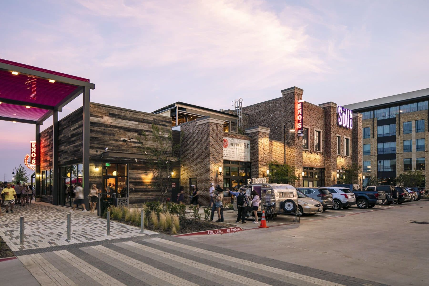 Open-air patio of the lakeside restaurants at Cypress Waters